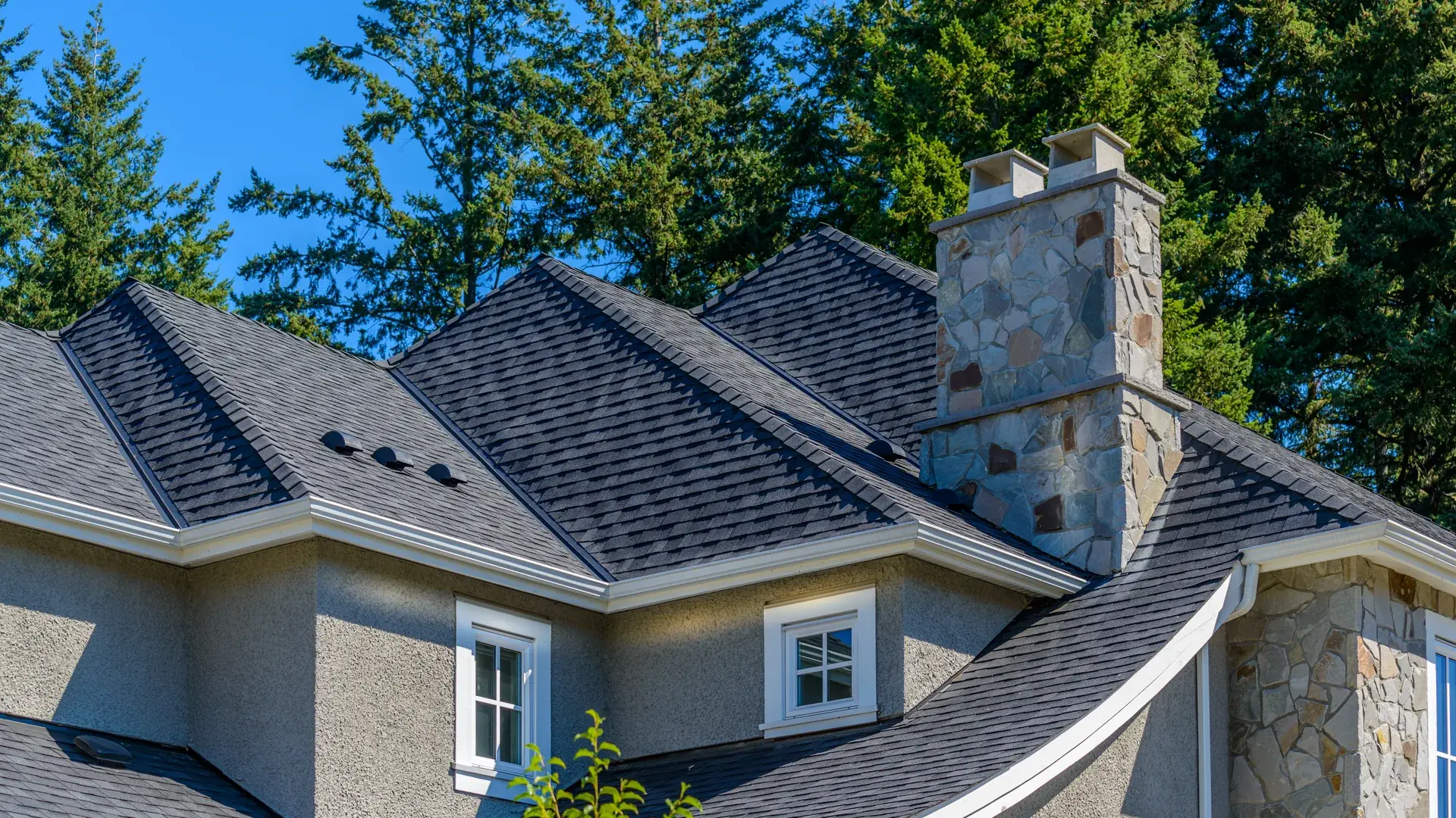 New roof going on a Castle Pines home at golden hour, pine ridge behind